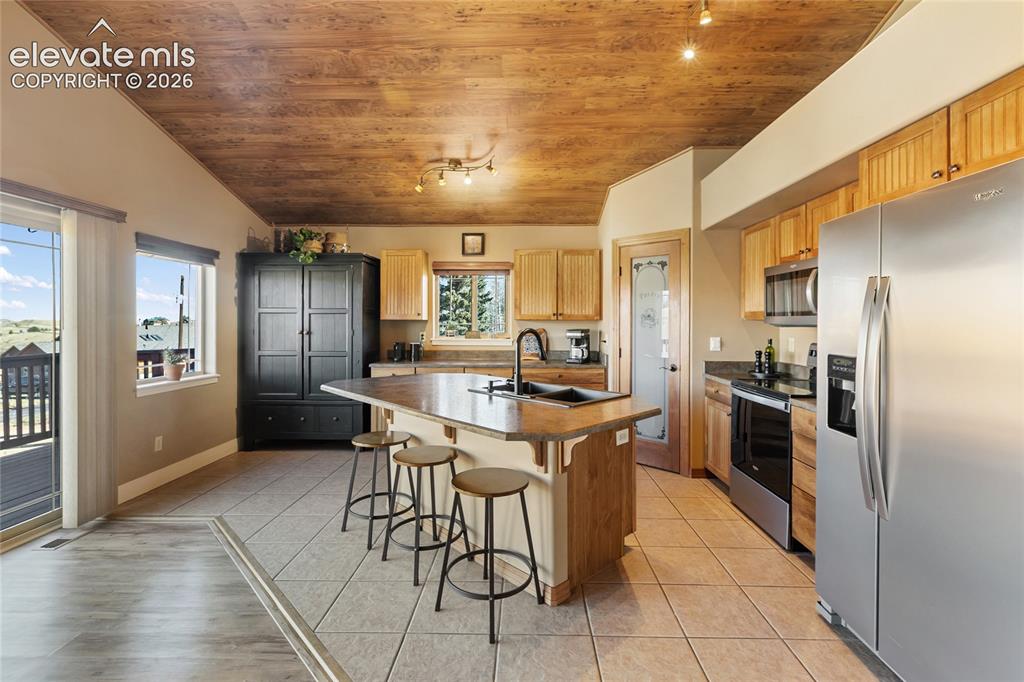 Image 11 of 30: The kitchen is meticulous with lots of space for storage, prep and entertai