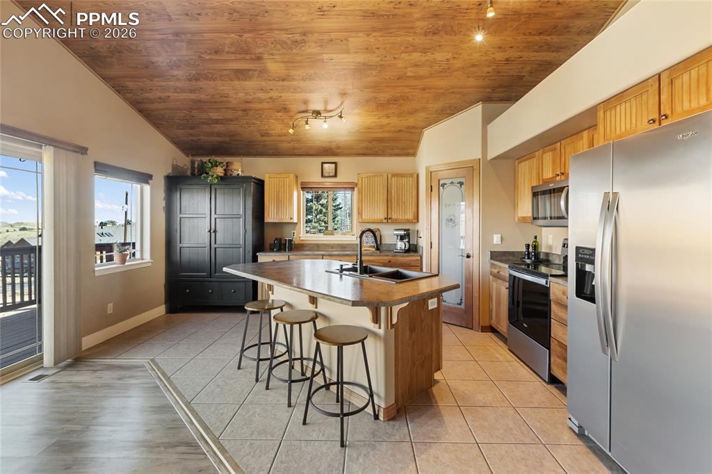 Image 17 of 33: The kitchen is meticulous with lots of space for storage, prep and entertai