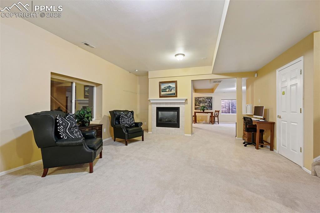 Image 41 of 50: Basement family room with large additional area and fireplace