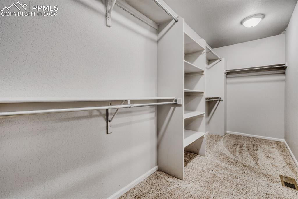 Image 19 of 37: Primary walk in closet