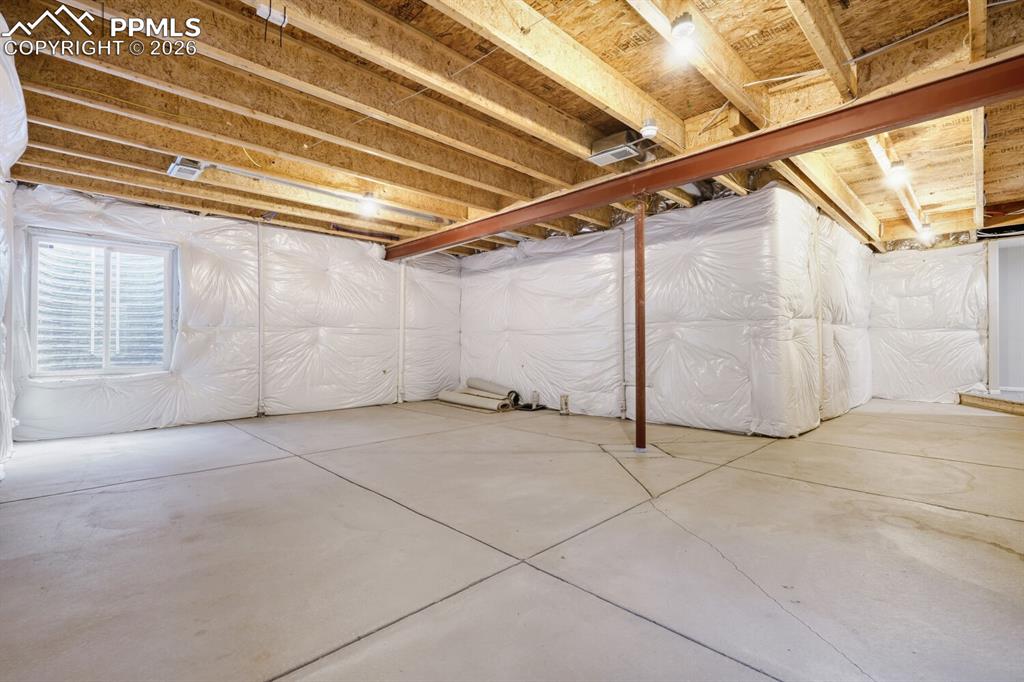 Image 27 of 37: unfinished basement with rough in for bathroom