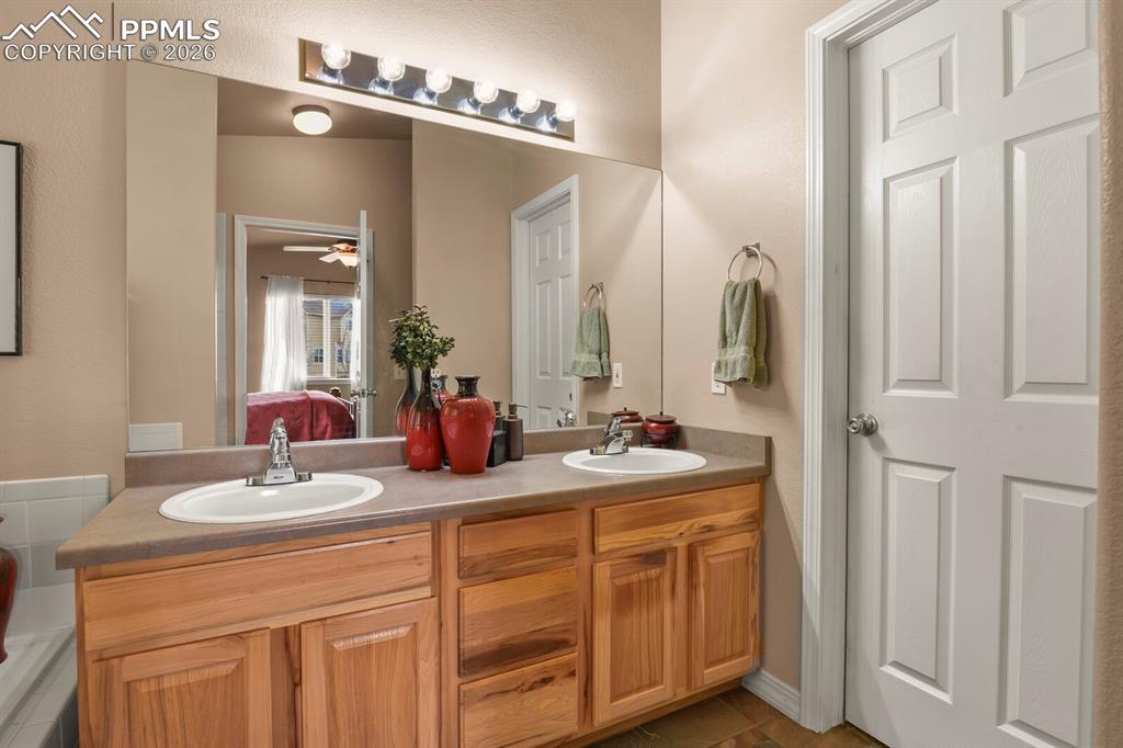 Image 21 of 42: Ensuite bathroom to the Primary Bedroom  with double vanities and door to t