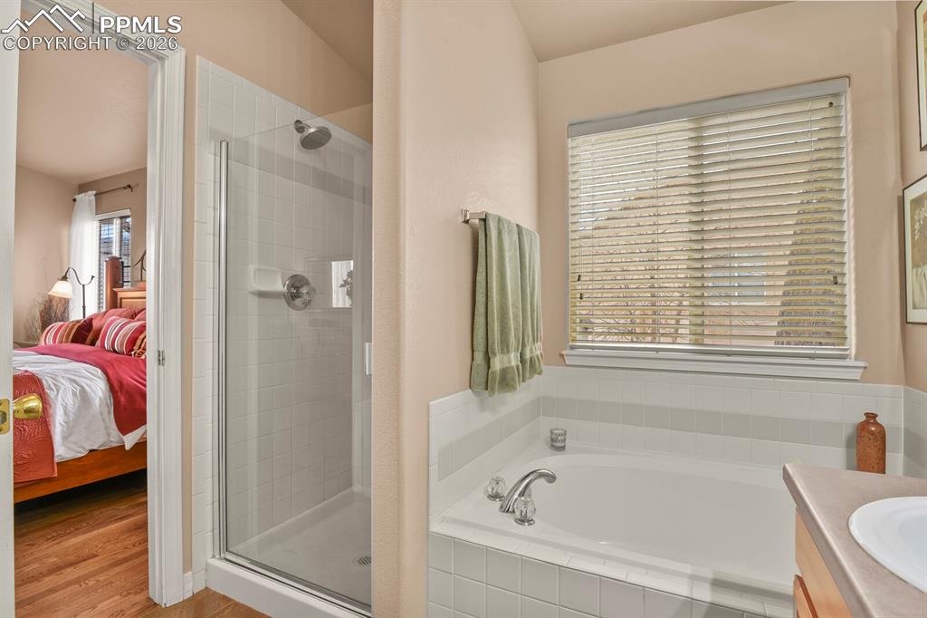 Image 22 of 42: Primary bathroom for the primary bedroom featuring a separate shower and so