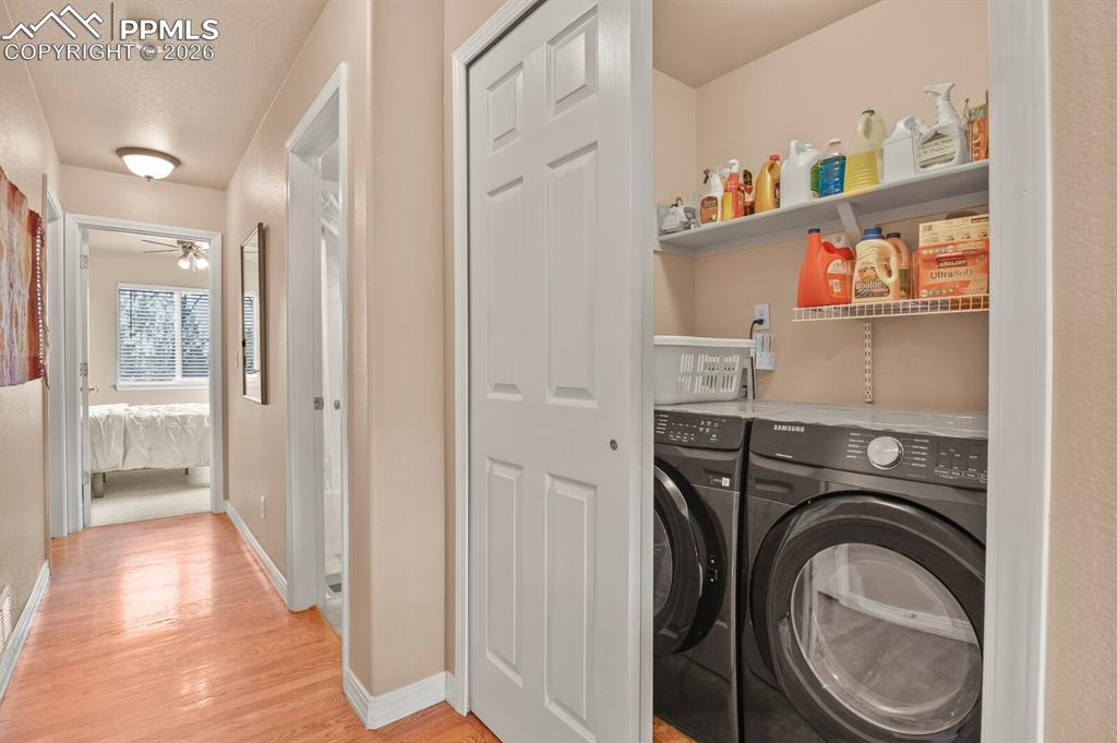 Image 28 of 42: Laundry area with shelving, washer and dryer EXCLUDED,