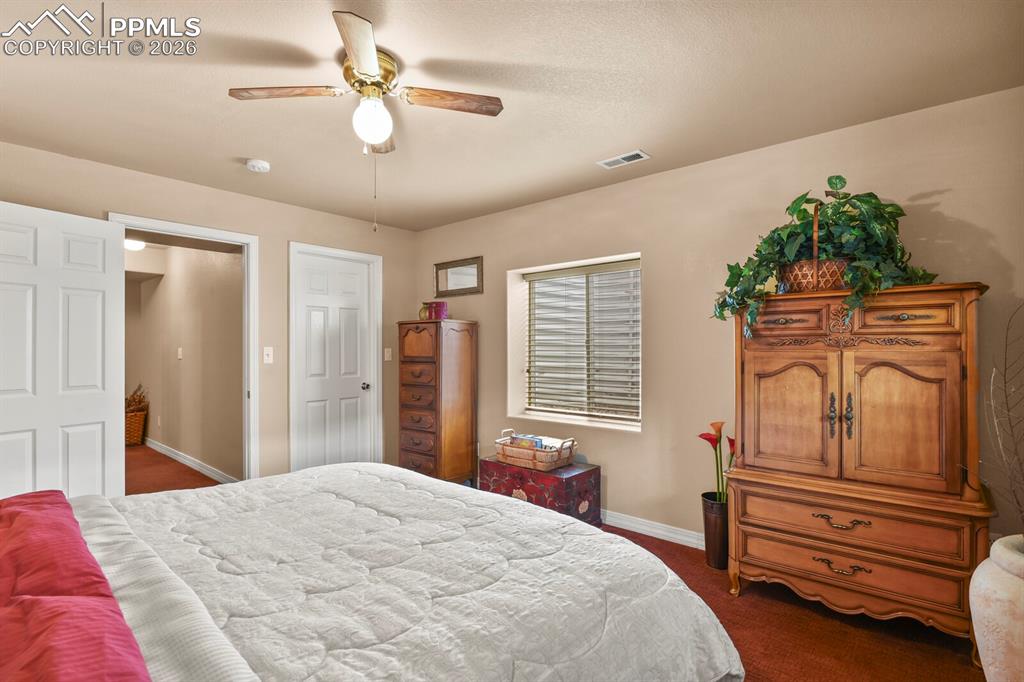 Image 35 of 42: 4th Bedroom in the basement  with a ceiling fan and dark carpet