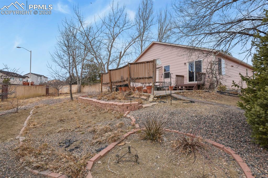 Image 38 of 42: View of the back of the home from the backyard.