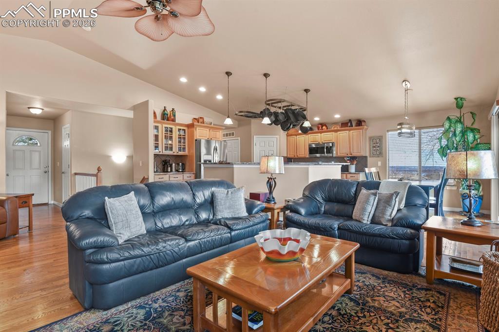 Image 8 of 42: Living room featuring ceiling fan, lofted ceiling, recessed lighting, and w