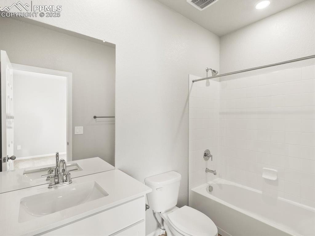 Image 20 of 26: Bathroom featuring vanity and shower / washtub combination