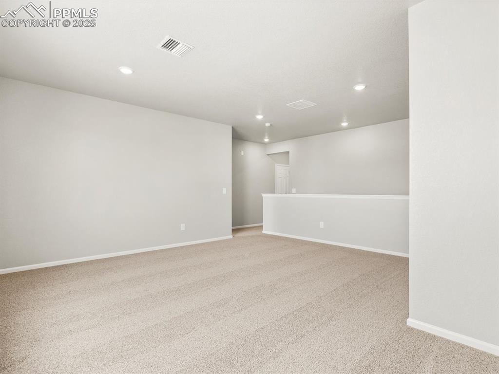 Image 8 of 26: Unfurnished room with light carpet and recessed lighting