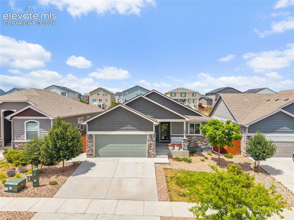 Image 1 of 50: Contemporary single-story residence featuring a two-car garage, stone and s