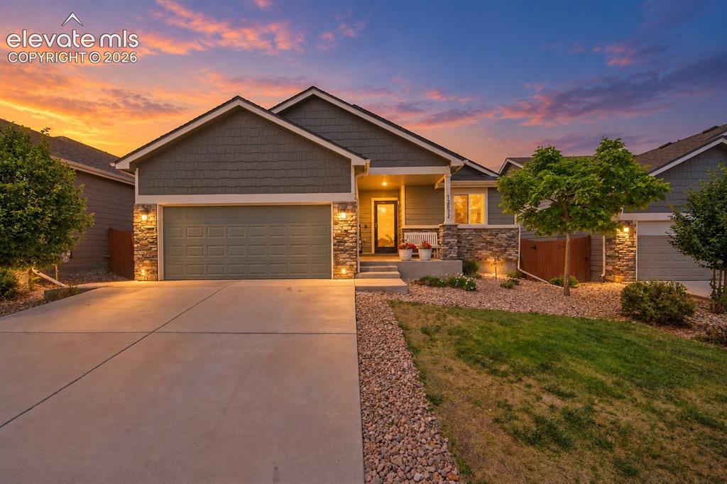 Image 1 of 49: Stone veneer and horizontal siding exterior, attached garage, concrete driv