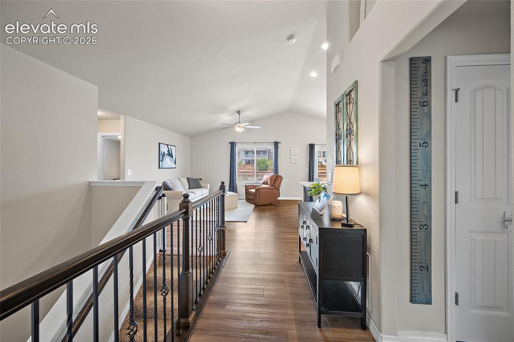 Image 14 of 49: Vaulted ceilings, wood-finish flooring, recessed lighting, and an open conc