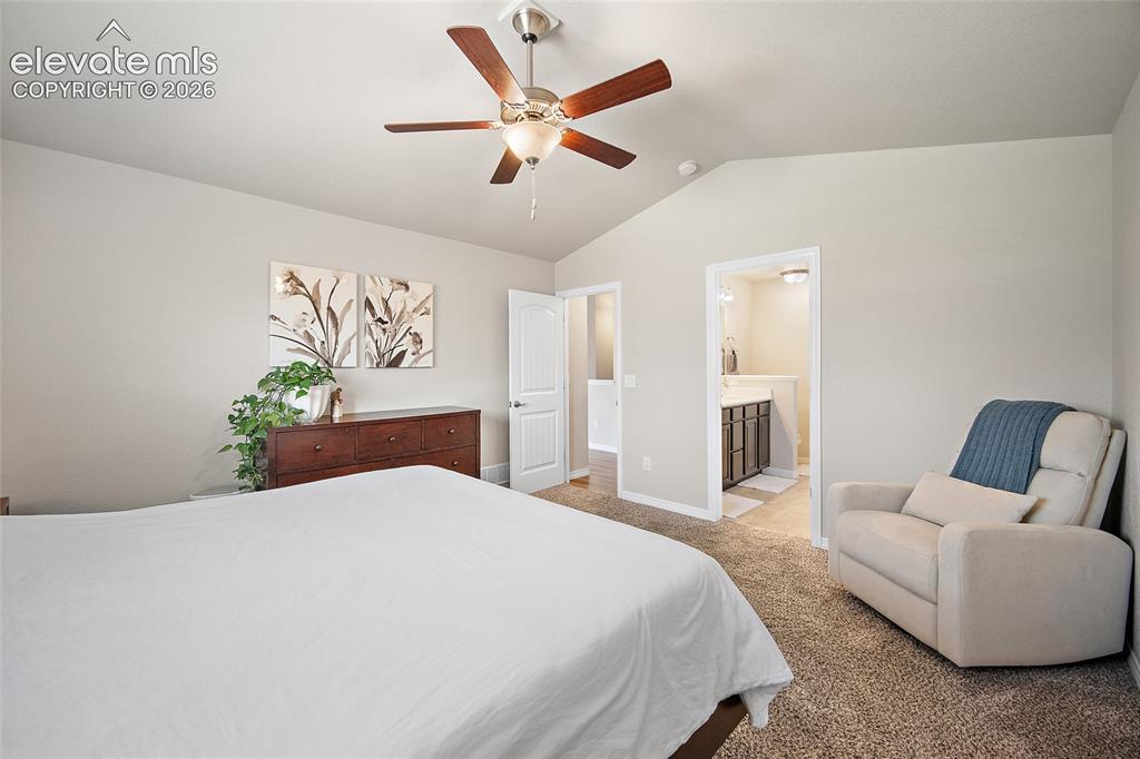 Image 15 of 49: Vaulted ceiling with a ceiling fan featuring wood-finish blades and integra