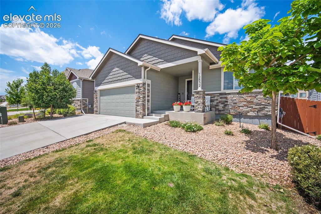Image 3 of 50: Contemporary exterior featuring siding, stone accents, and a covered porch