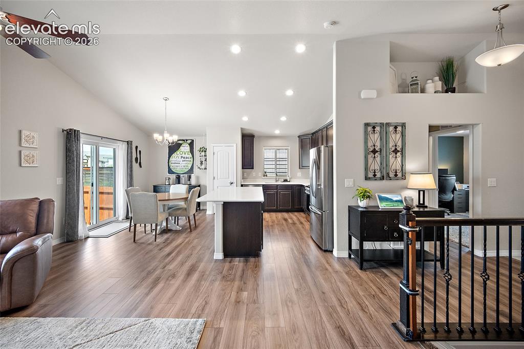 Image 3 of 49: Open-concept interior featuring wood-finish flooring, vaulted ceilings, rec