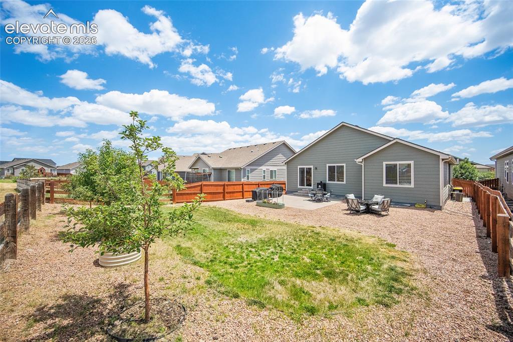 Image 36 of 49: Expansive backyard featuring a partial-gravel ground cover, a grassy area,