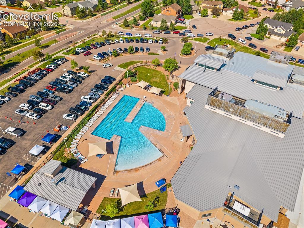 Image 39 of 49: Community recreation area featuring an outdoor swimming pool complex with m