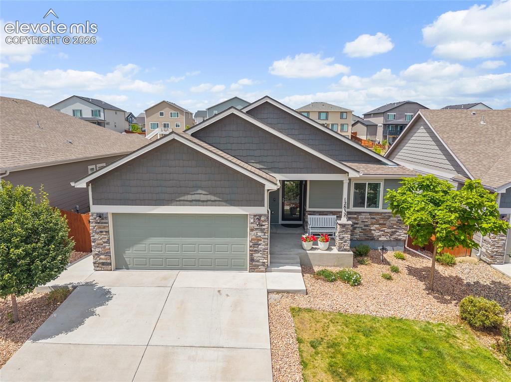 Image 45 of 49: Single-story residence featuring a two-car garage with a concrete driveway