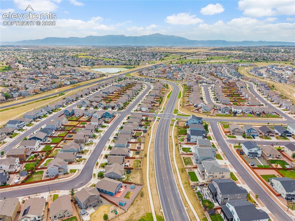 Image 46 of 50: Aerial overview of a residential development with distinct housing styles,