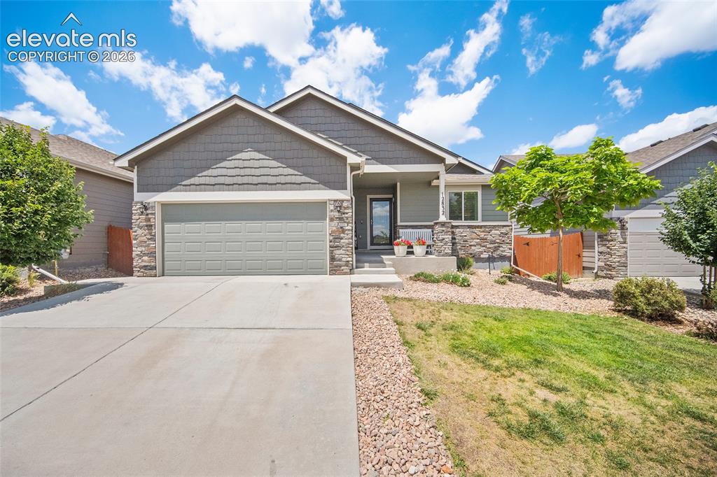 Image 48 of 49: Contemporary ranch-style residence featuring a stone and siding facade