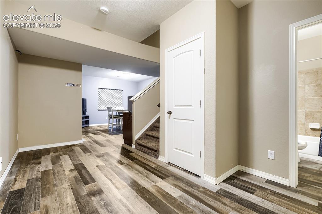 Image 23 of 32: Basement foyer with understairs storage