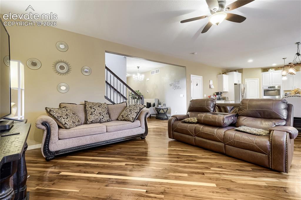 Image 9 of 32: Spacious interior with wood flooring, perfect for entertaining