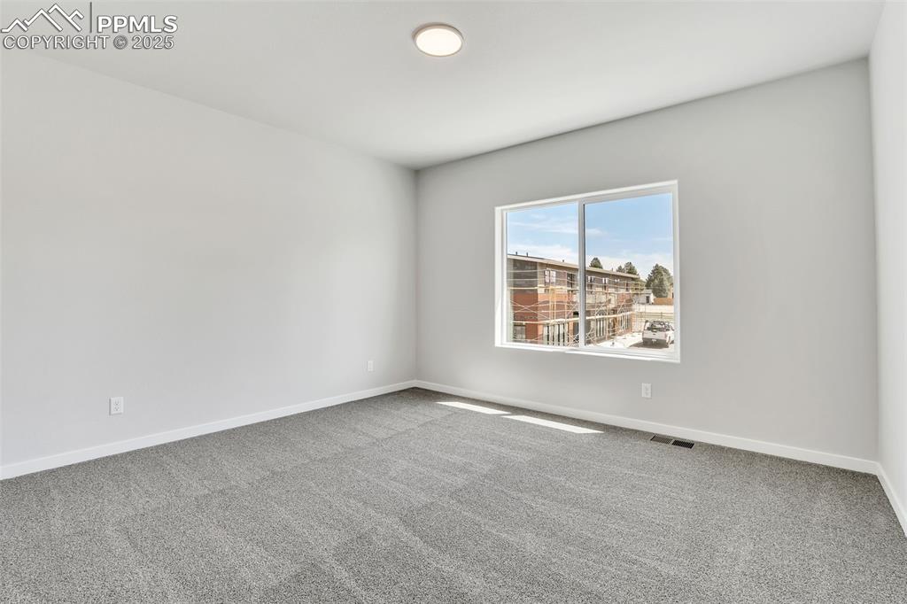 Image 17 of 29: Carpeted spare room with visible vents and baseboards