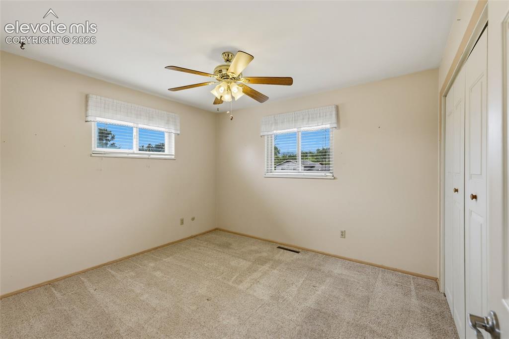 Image 16 of 43: Neutral-toned walls complement the textured carpeting