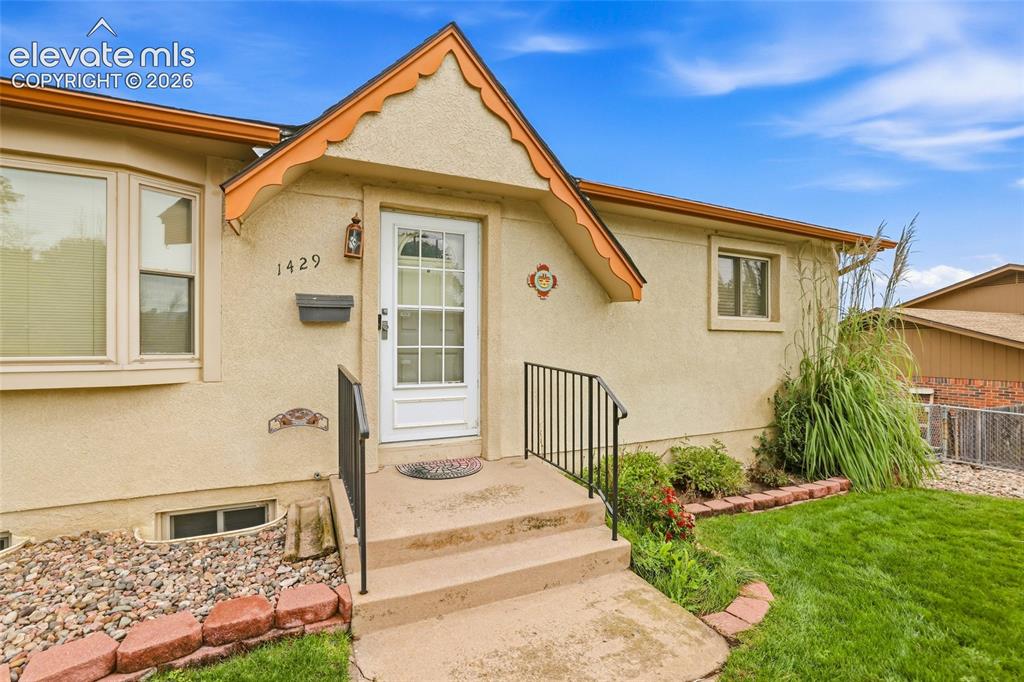Image 3 of 43: Stucco exterior with a decorative gable, main entry with a white paneled do