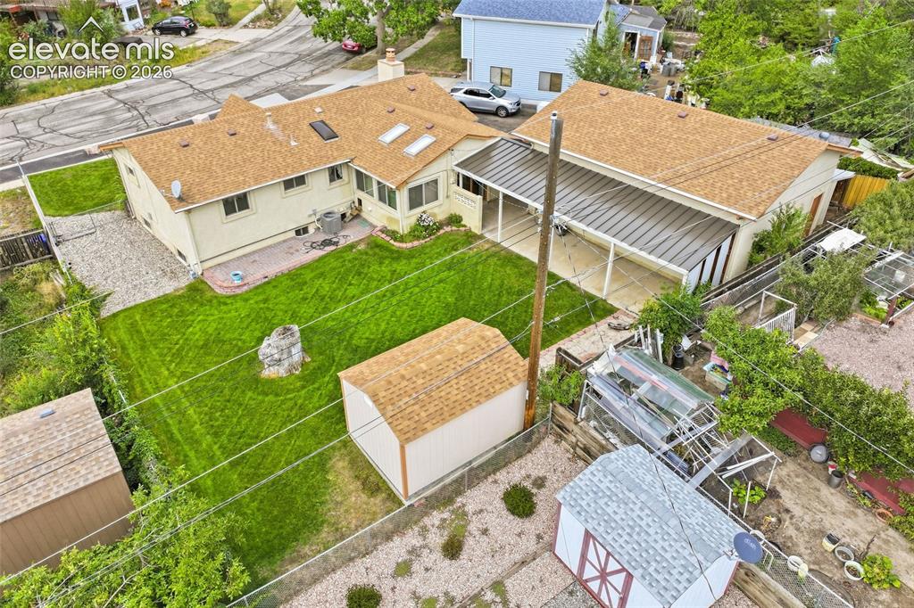 Image 34 of 43: Expansive property featuring a main residence with skylights, an attached c