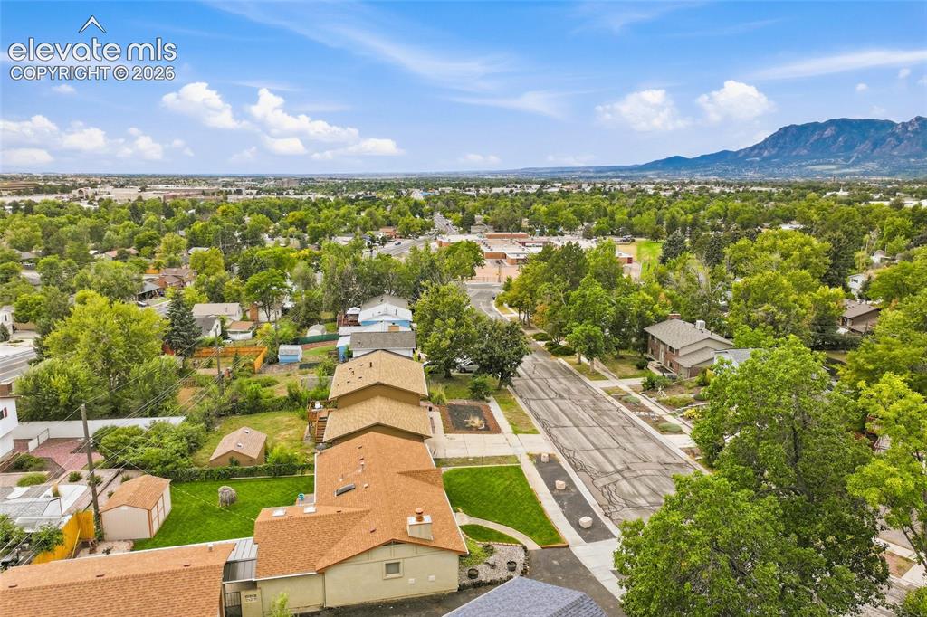 Image 35 of 43: Expansive green spaces and mature trees surround the property
