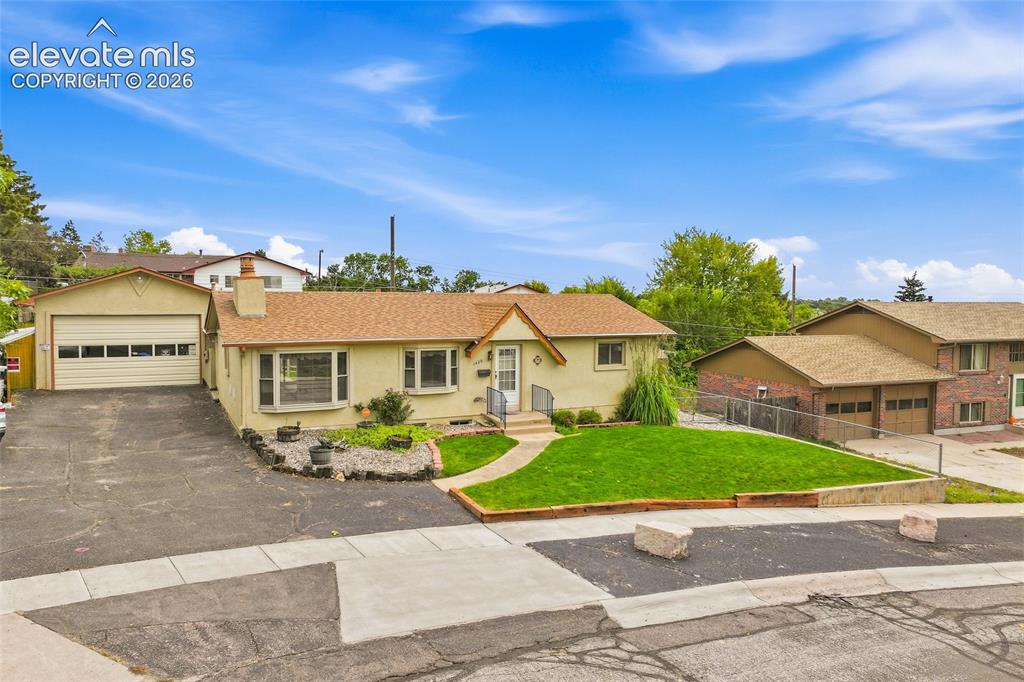 Image 36 of 43: Paved driveway leading to an attached two-car garage