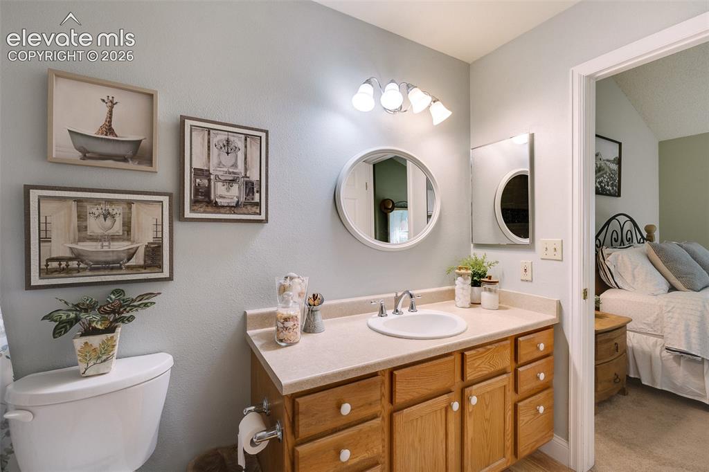 Image 10 of 27: The Primary Bathroom offers a vanity, mirror, and tiled tub/shower.