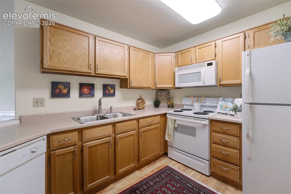 Image 13 of 27: The kitchen features abundant cabinetry, generous workspace, and appliance