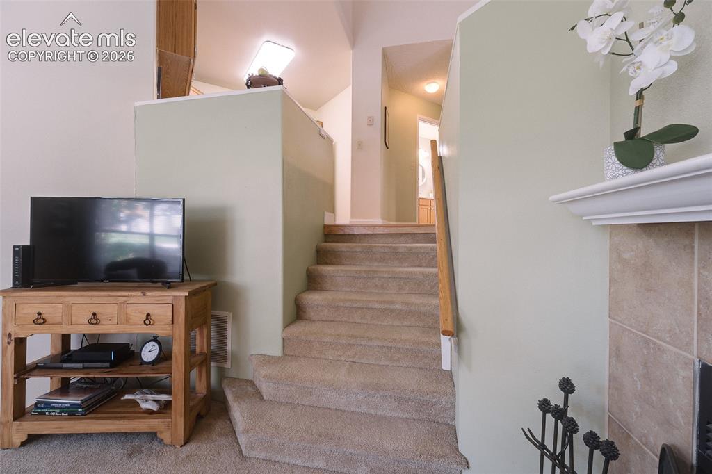 Image 14 of 27: Stairs from the Kitchen to the Living Room.
