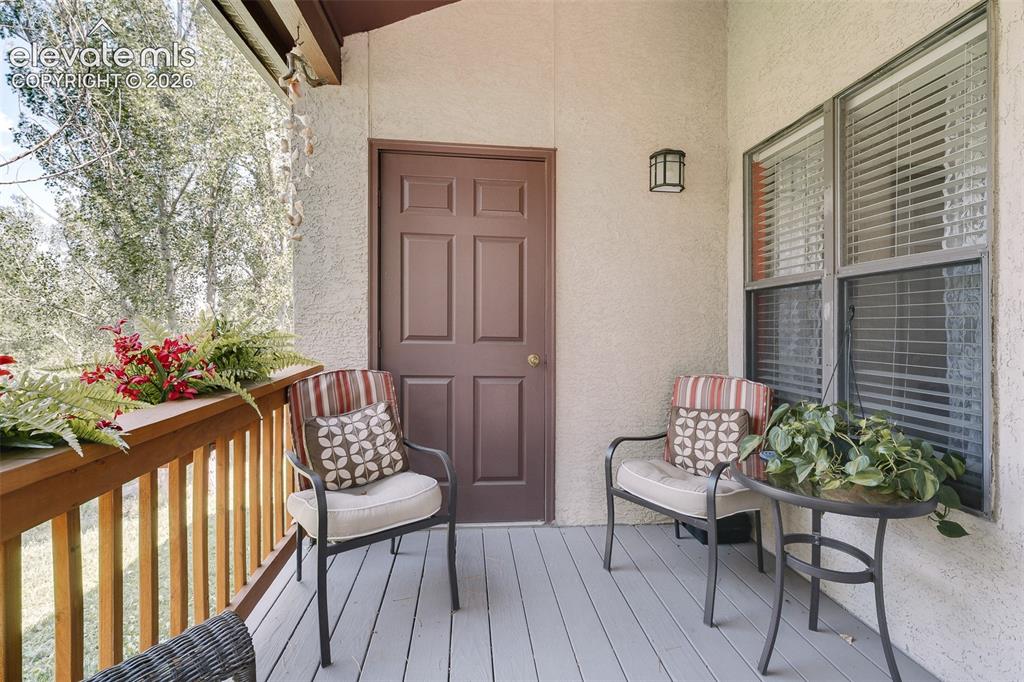 Image 16 of 27: Composite deck overlooking mature pines and wooded open space, creating a p