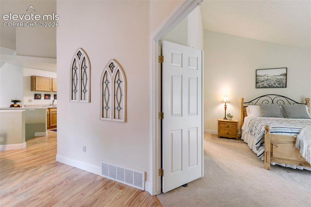 Image 5 of 27: Entry into the Primary Bedroom and Kitchen.