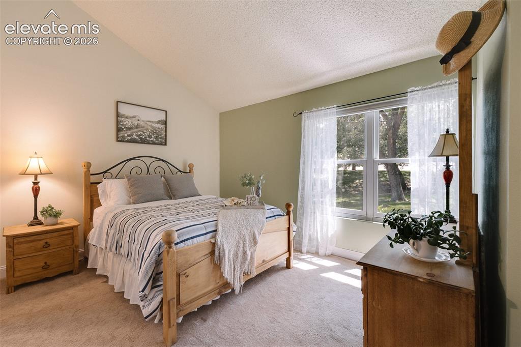 Image 6 of 27: The main-level primary suite features double doors, a walk-in closet and pr