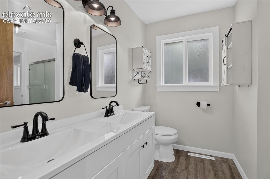 Image 12 of 26: Updated primary bath w/ dual sink vanity