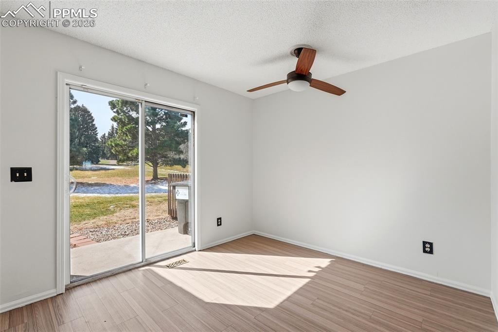 Image 14 of 44: Dining room featuring light wood finished floors, a textured ceiling, and a