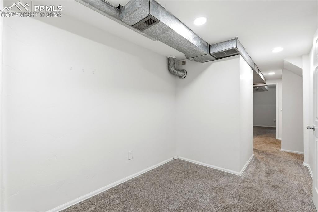 Image 15 of 44: Walk in closet with carpet