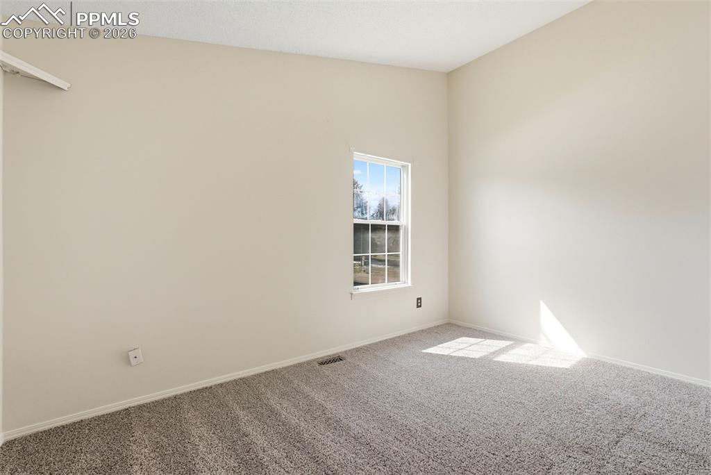 Image 18 of 44: Unfurnished room with carpet and baseboards