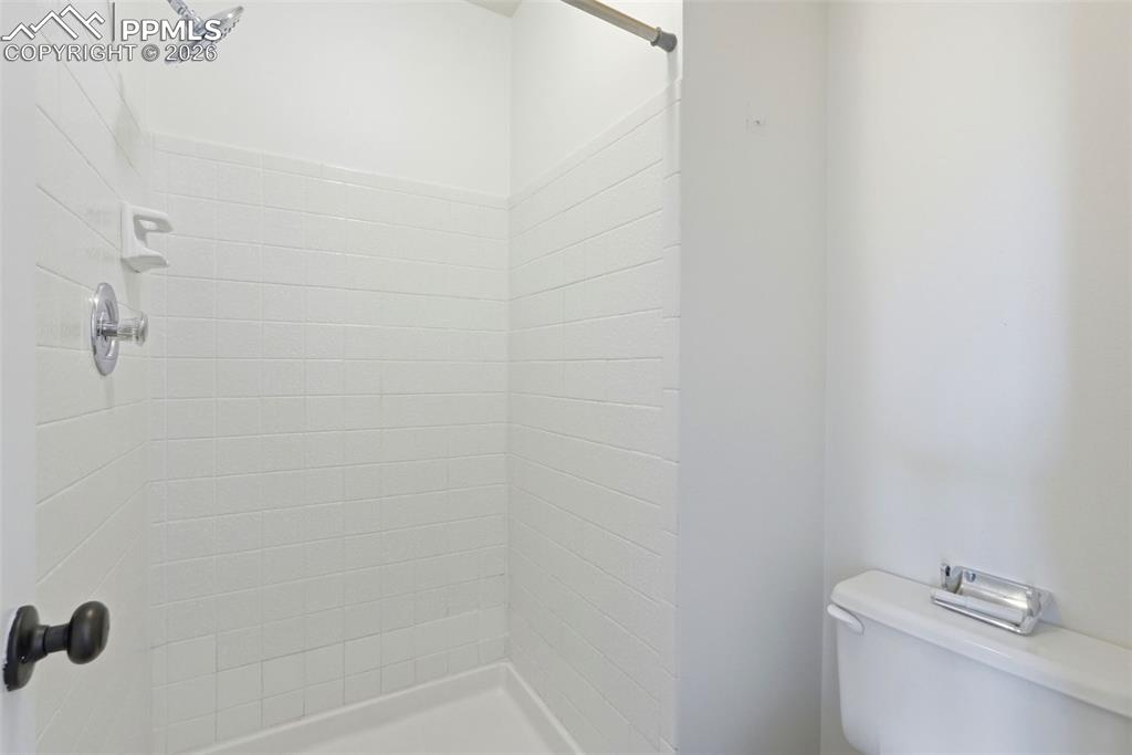 Image 26 of 44: Full bathroom with toilet and a stall shower