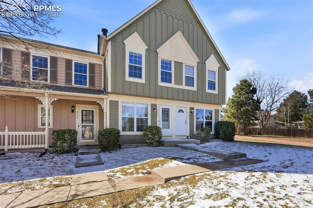 Image 3 of 44: View of front of house with board and batten siding and covered porch