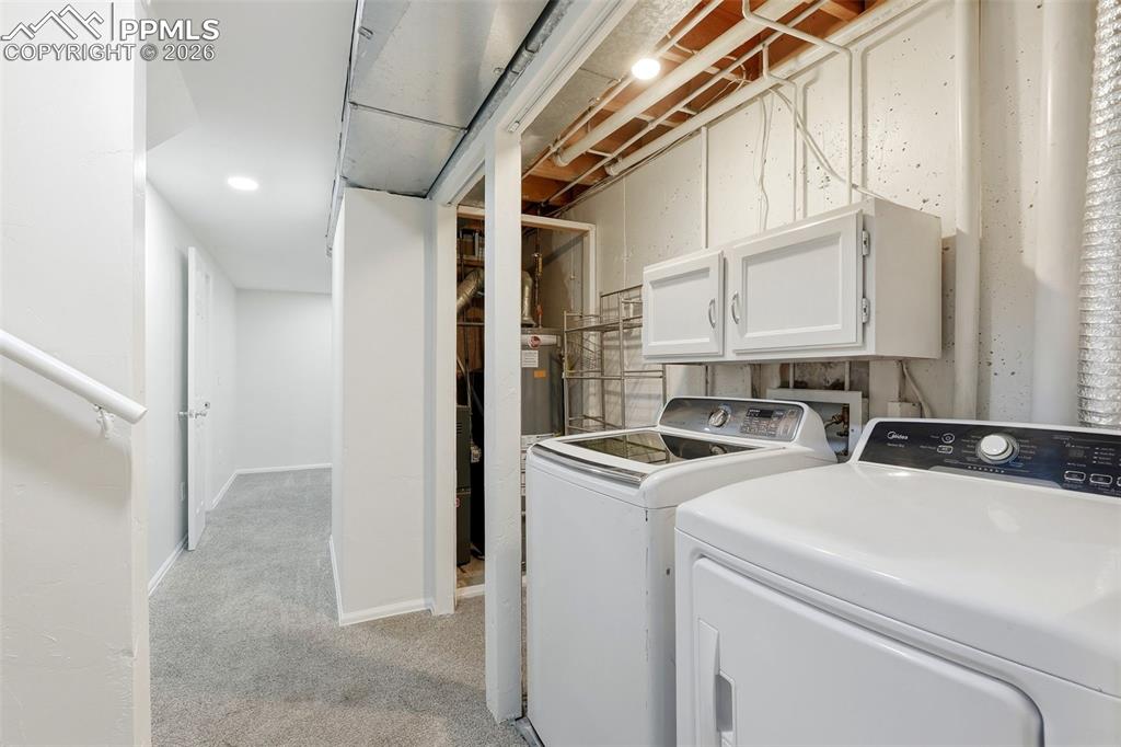 Image 36 of 44: Laundry room featuring cabinet space, independent washer and dryer, light c