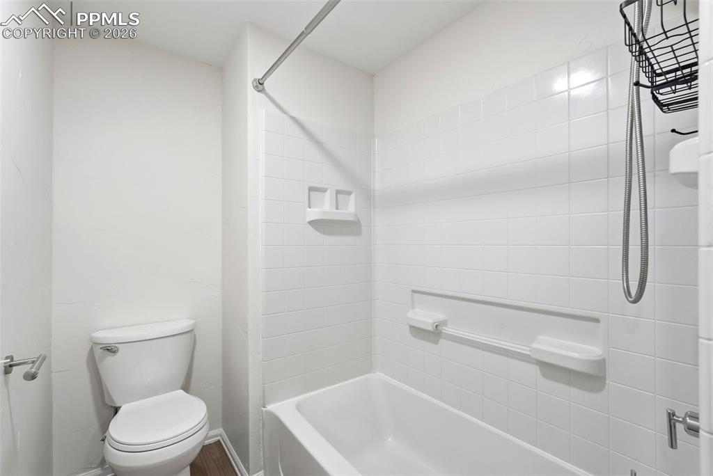 Image 37 of 44: Bathroom featuring toilet and  shower combination