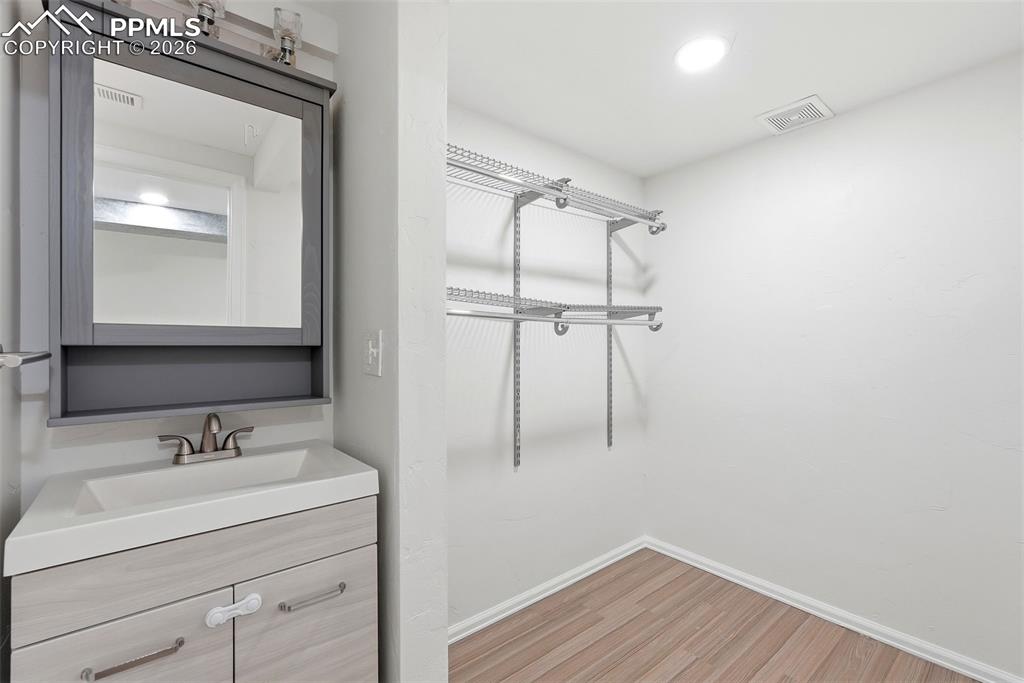 Image 38 of 44: Bathroom featuring vanity, light wood finished floors, and recessed lightin