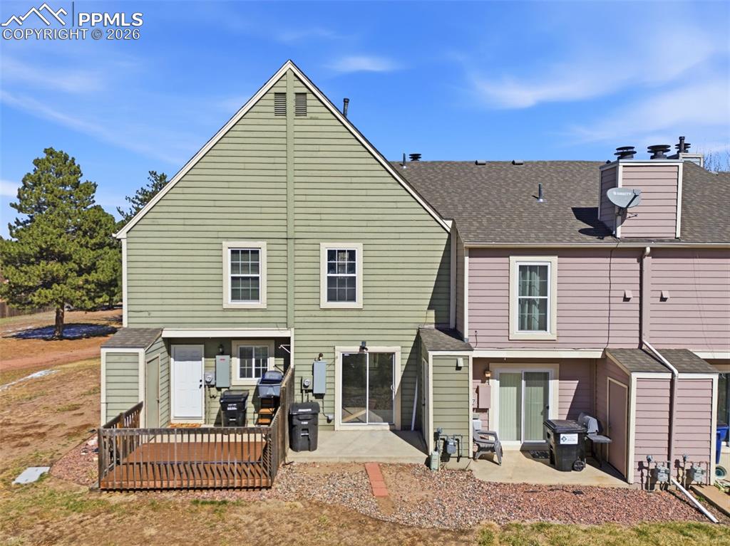 Image 40 of 44: Back of house with a storage shed, a patio area, and a shingled roof