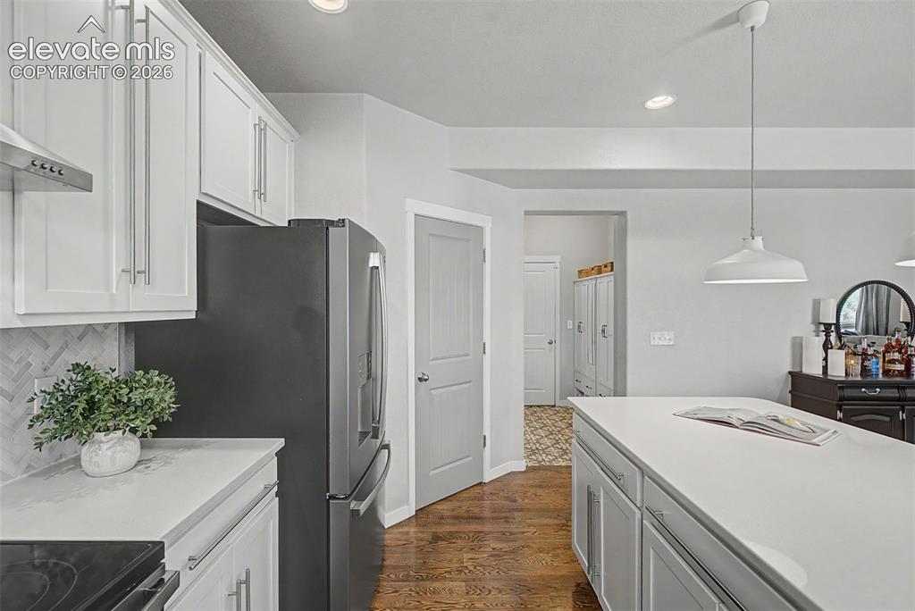 Image 14 of 40: Just beyond the kitchen is easy access to powder room, space for all your g