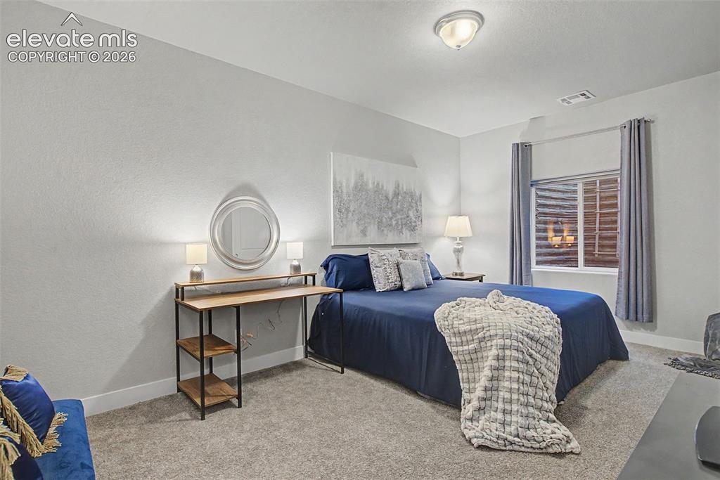 Image 30 of 40: 5th bedroom is very private in the lower level, on its own hallway, with a 